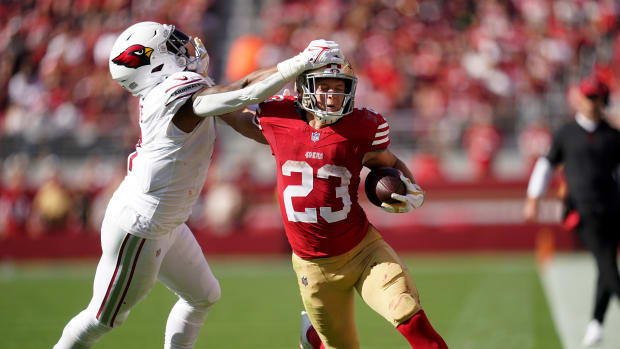 Oct 1, 2023; Santa Clara, California, USA; San Francisco 49ers running back Christian McCaffrey (23) stiff arms Arizona Cardinals linebacker Kyzir White (7) in the third quarter at Levi's Stadium.